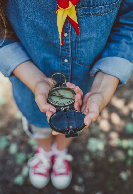 child holding compass