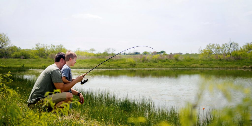 boy fishing with dad