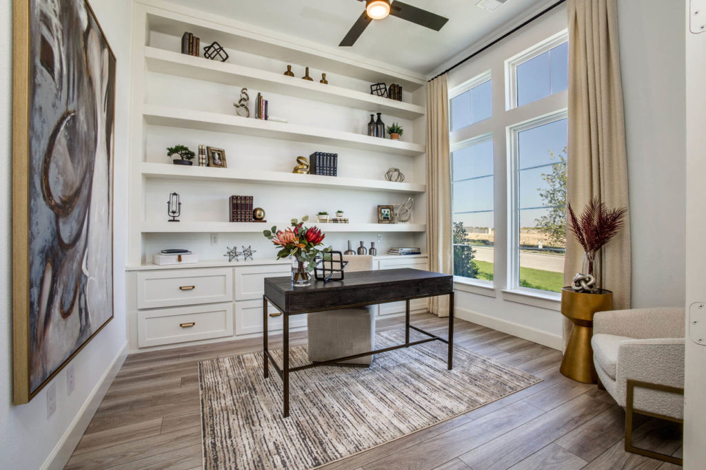 A McKinney home office with white shelves and a ceiling fan.