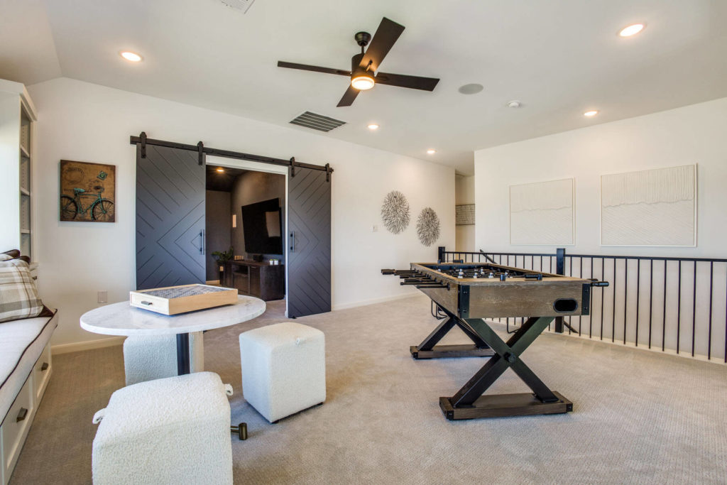 A new game room in a Texas house with a foosball table and chairs.