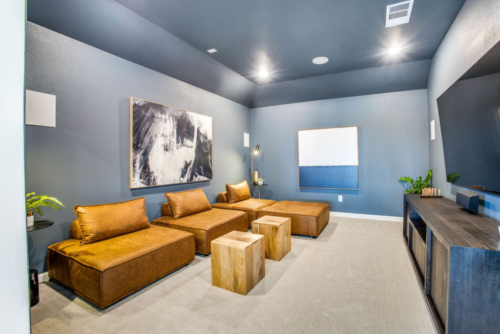 A living room with a TV and couches in a new home in McKinney.
