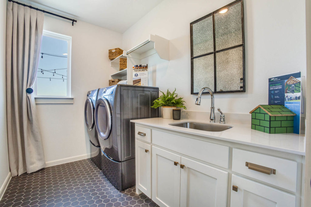 A laundry room in a new home with a washer and dryer.