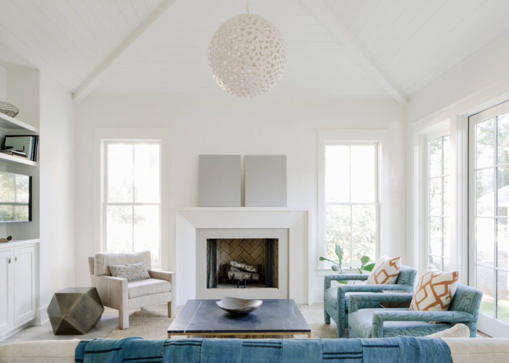 A white living room with blue furniture and a fireplace in McKinney, Texas.