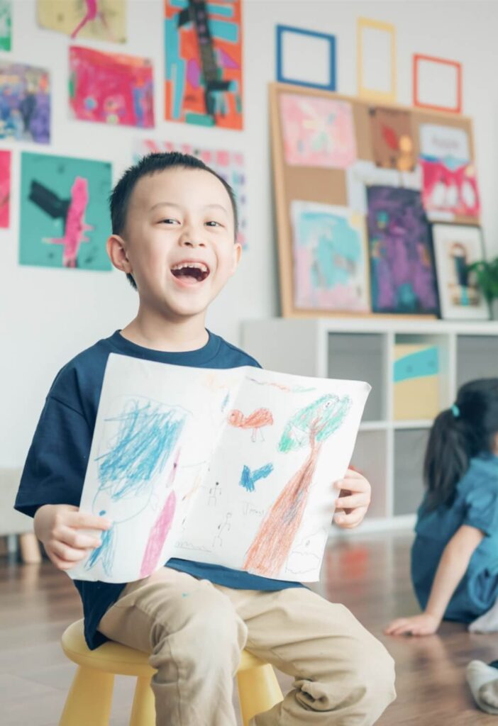 a young student showcasing their art