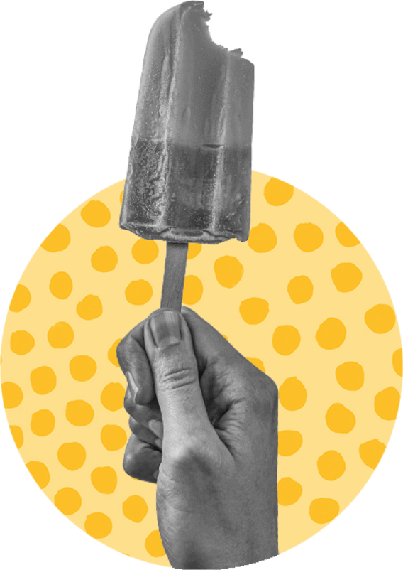 A hand holding a popsicle on a yellow background, offering a refreshing treat on a hot Texas day.