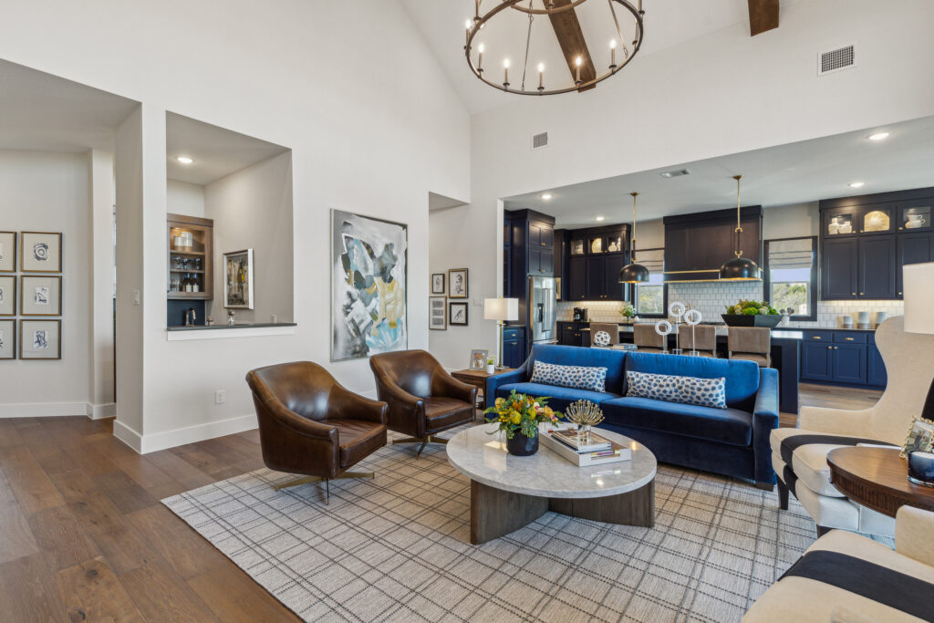In a new home in McKinney, a living room boasts blue couches and hardwood floors.