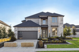 Modern two-story brick house by Trophy Signature Homes with a double garage and landscaped front yard under a clear blue sky, located in McKinney, TX.