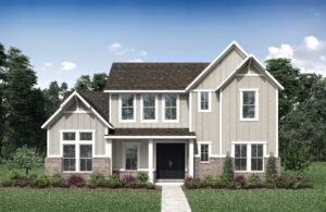 A two-story house with beige siding, large windows, and a dark roof, surrounded by a green lawn and trees under a blue sky.