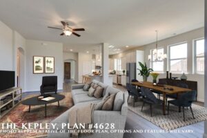 Open-concept living and dining area with a sectional sofa, dining table, modern kitchen, ceiling fans, and large windows. Text on the image displays "The Kepley, Plan #4628"—discover Painted Tree McKinney homes for sale in McKinney, Texas.