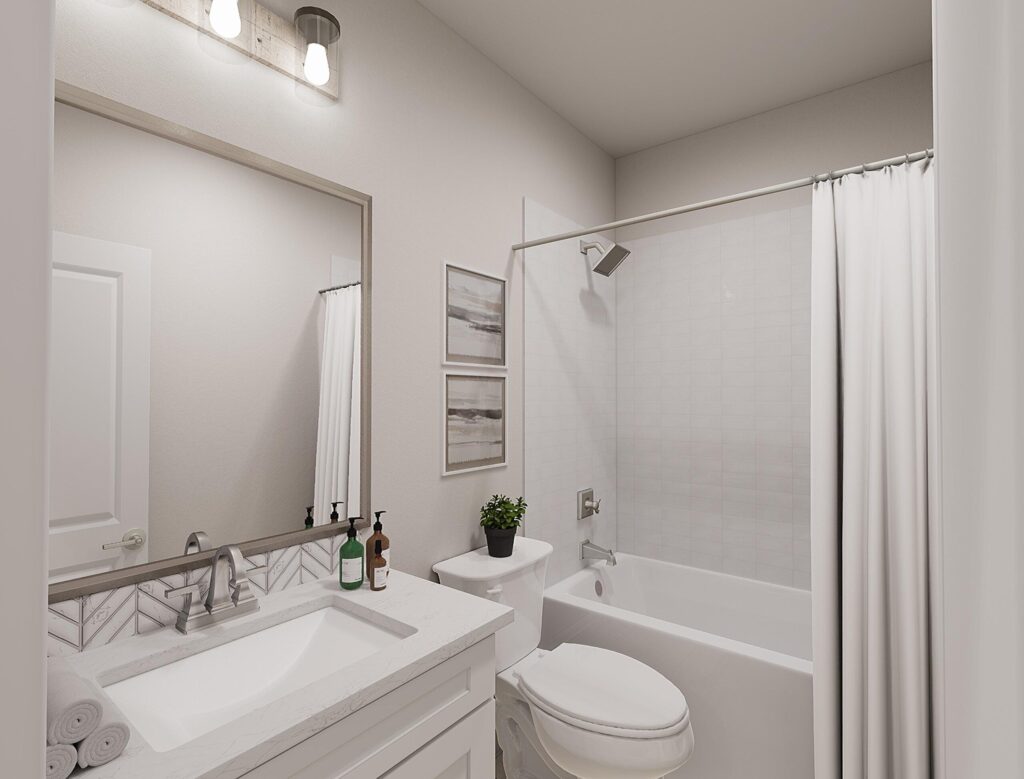Modern bathroom in Painted Tree McKinney with a white sink, countertop, cabinetry, toilet, bathtub with shower and curtain, framed art, and toiletries on the counter—discover stylish living in homes for sale in McKinney Texas.