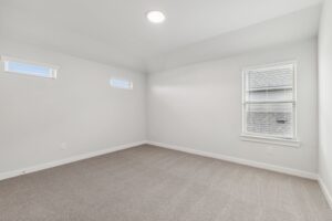 Empty room with beige carpet, white walls, three windows with blinds, and a ceiling light—ready for your touch in sought-after Painted Tree McKinney. Explore Painted Tree homes for sale and discover comfortable living in this vibrant community.