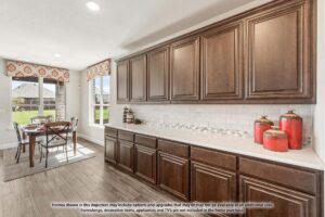 A kitchen with dark wood cabinets, white tile backsplash, and decorative jars on the counter. A dining table with chairs is visible near large windows—perfect for enjoying the view in Painted Tree TX homes for sale.