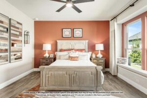 Bedroom with a wooden bed, matching nightstands and lamps, two framed prints above the headboard, wood-look tile flooring, and a large window with a cushioned bench—perfect for those seeking homes for sale in McKinney Texas or Painted Tree McKinney.