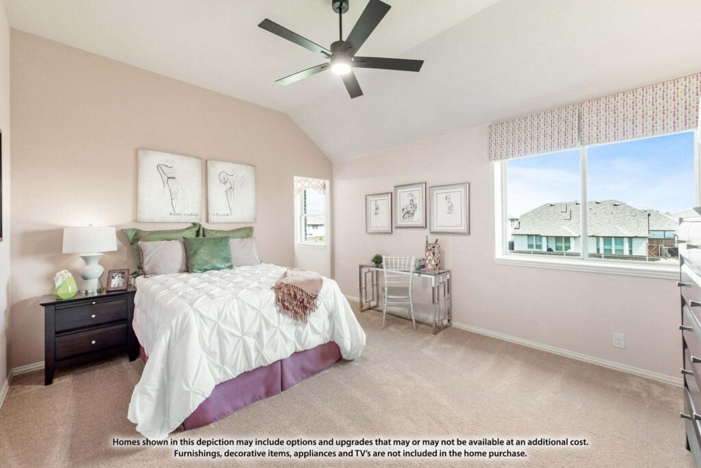 A bedroom in Painted Tree McKinney features a large bed, nightstands, wall art, a ceiling fan, and two windows letting in natural light—perfect for those seeking homes for sale in McKinney, Texas.