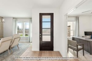 A modern entryway with a dark wooden door, adjacent to a bright living area with armchairs and a separate office space—perfect for those exploring homes for sale in McKinney, Texas or seeking inspiration at Painted Tree McKinney.