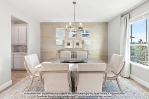 Modern dining room with six upholstered chairs, a rectangular table, chandelier, wall art, and large windows letting in natural light—ideal for those seeking Painted Tree McKinney homes for sale. Text disclaimer visible along the bottom edge.