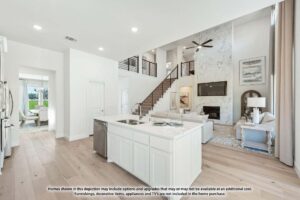 Modern open-concept living area in Painted Tree McKinney, featuring a white kitchen island, stainless sink, and adjacent living room with high ceilings, large windows, and a stylish staircase with railing.