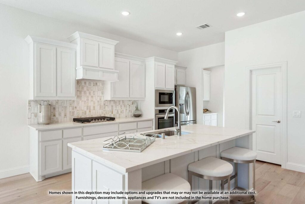 Modern kitchen with white cabinets, stainless steel appliances, center island with sink, two stools, and neutral tile backsplash; bright, open layout—perfect for those seeking Painted Tree McKinney homes for sale.