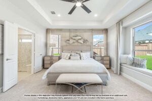 Bright, modern bedroom with a large bed, two nightstands, wall art, and spacious windows overlooking a fenced backyard—perfect for enjoying serene Painted Tree McKinney views. Text disclaimer at the bottom.