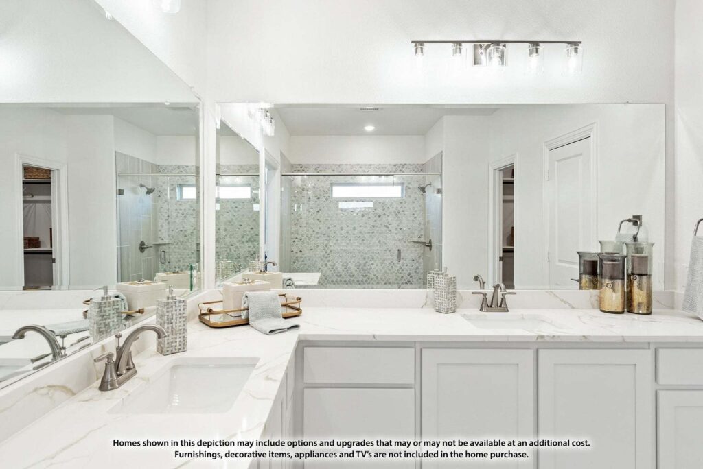 Modern bathroom with double sinks, marble countertop, large mirror, glass shower, and neutral decor—just one of many stylish features in homes for sale in McKinney Texas. Disclaimer text is visible at the bottom.
