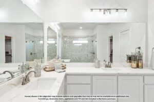 Modern bathroom with double sinks, marble countertop, large mirror, glass shower, and neutral decor—just one of many stylish features in homes for sale in McKinney Texas. Disclaimer text is visible at the bottom.