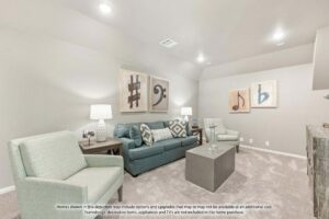 A modern living room with light-colored walls, a blue-gray sofa, armchairs, art, lamps, and carpeted flooring—perfect for those exploring Painted Tree homes for sale or searching for homes for sale in McKinney, Texas. Items not included in home purchase.