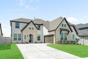 Two-story modern house with light brick exterior, arched windows, double garage, and large driveway. Located near painted tree TX, this home is surrounded by a well-maintained green lawn—ideal for those seeking homes for sale in McKinney Texas.