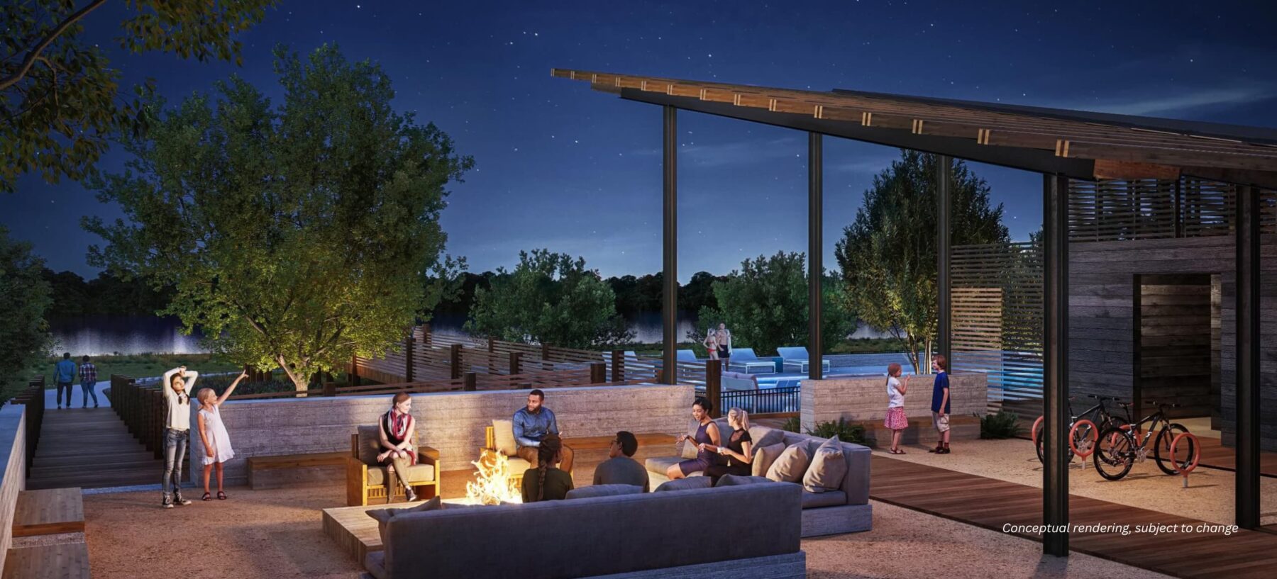 People relax around a fire pit on a patio at dusk, with chairs and sofas. Trees and a pool are visible in the background.