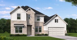 Two-story suburban house by Coventry Homes in Painted Tree features light brick and white siding, a black roof, attached two-car garage, and a manicured lawn under a partly cloudy sky—ideal for those seeking stylish new homes.
