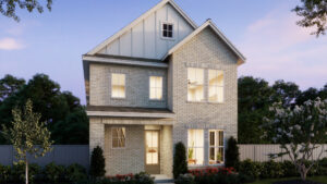A two-story brick house by Normandy Homes with large windows, a covered entryway, and a small landscaped front yard in Painted Tree, McKinney—set against a backdrop of trees and a fence at dusk.