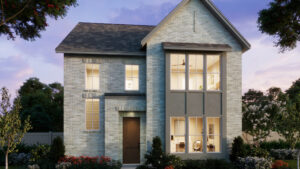 Two-story modern brick house by Normandy Homes in Painted Tree, McKinney features large front windows, illuminated interior, and landscaped yard, beautifully photographed at dusk.